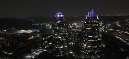 Drone photo of King and Queen building in Sandy Springs lit purple